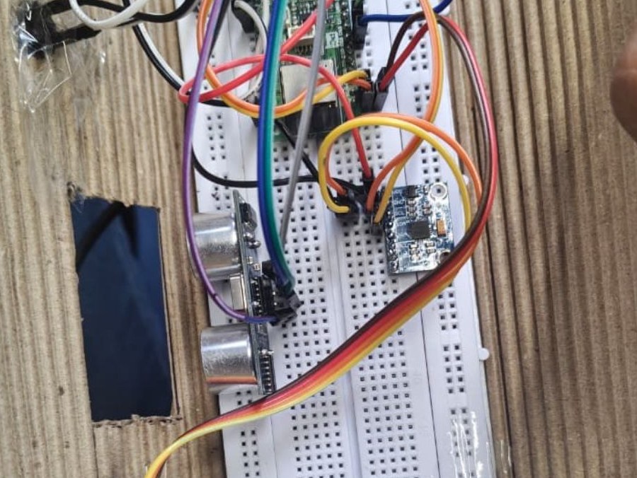 Sensors wired on a breadboard inside the cardboard shell