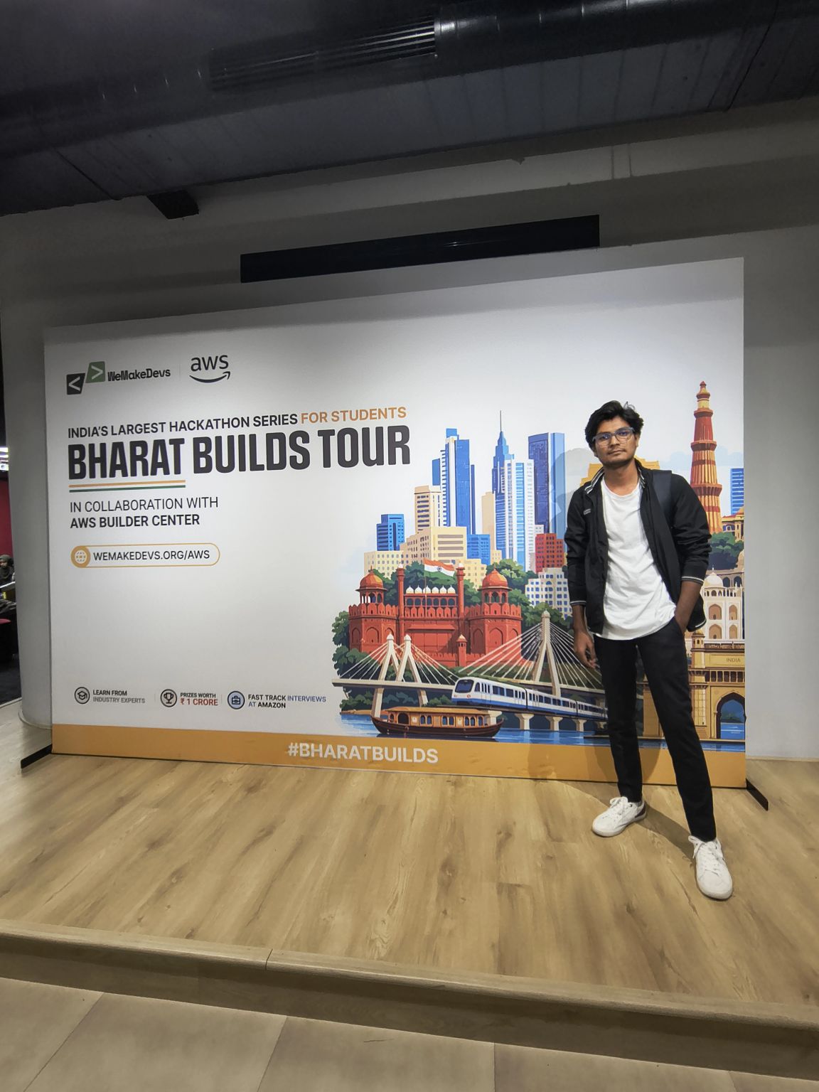 At the Bharat Builds Tour banner by WeMakeDevs and AWS