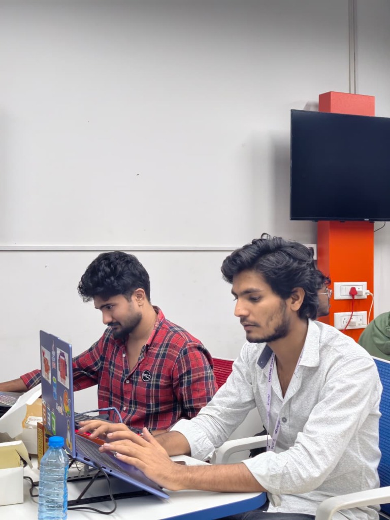Naiyar and teammate deep in code debugging the C# client and inference loop